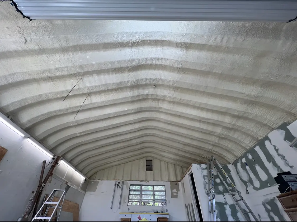 Spray polyurethane foam applied to the underside of a metal roof deck in Marquette